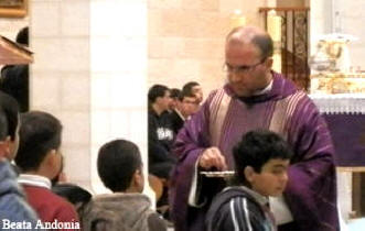 Priest clothed in traditional purple robe for Lent - Ash Wednesday Celebration in the Church of Nativity in Bethlehem, West Bank
